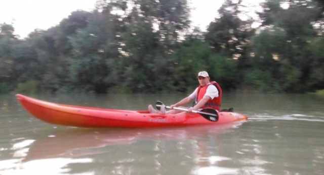  man sitting in a red canoe 